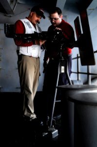 US Navy 110131-N-8040H-113 Lt. Brian Hellmann, left, and Gunner's Mate 2nd Class Ralph Bucci inspect the weapon mount on the executive officer's sp