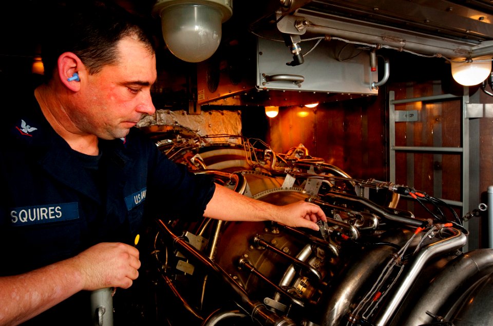 US Navy 110204-N-9589S-195 Gas Turbine System Technician (Electrical) 3rd Class Christopher A. Squires verifies a repair on a gas turbine engine