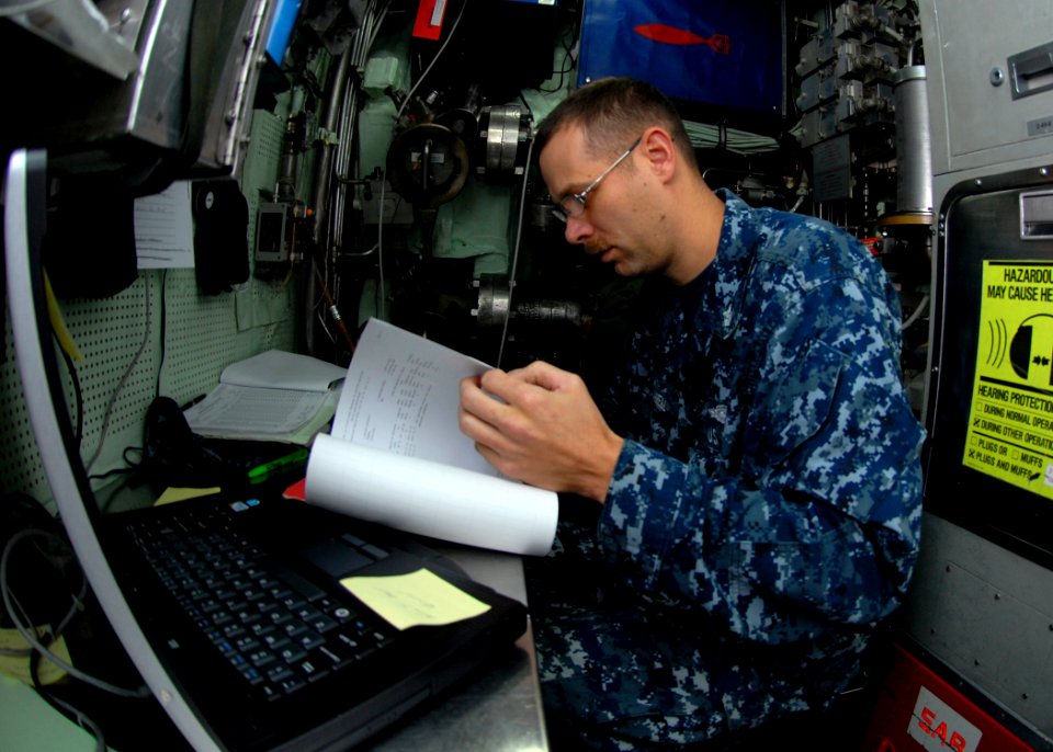 US Navy 110202-N-7705S-009 Hospital Corpsman 1st Class Kevin Caldwell reviews a health record in the medical office aboard the Los Angeles-class at