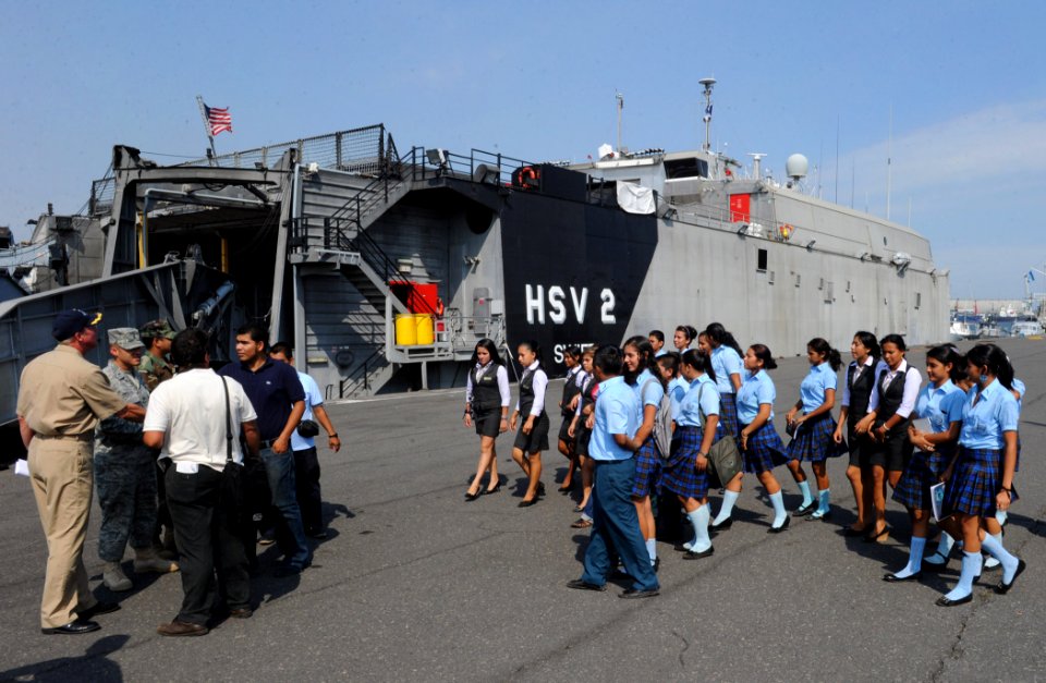 US Navy 110207-N-7589W-012 Students and faculty from Colegio Liceo Alpha ^ Omega approach the High Speed Vessel Swift (HSV 2) for a tour as part of