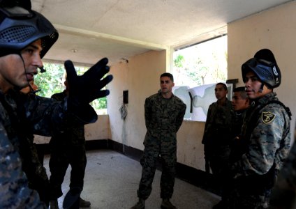 US Navy 110203-N-7589W-017 A member of the Guatemalan navy special forces, left, discusses basic urban skills training procedures