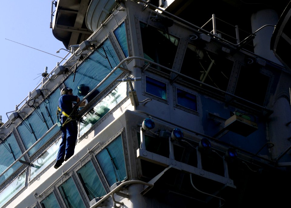 US Navy 110203-N-3154P-027 Aviation Boatswain's Mate (Handling) Airman Adam Chandler cleans the windows of Primary Flight Control aboard the amphib