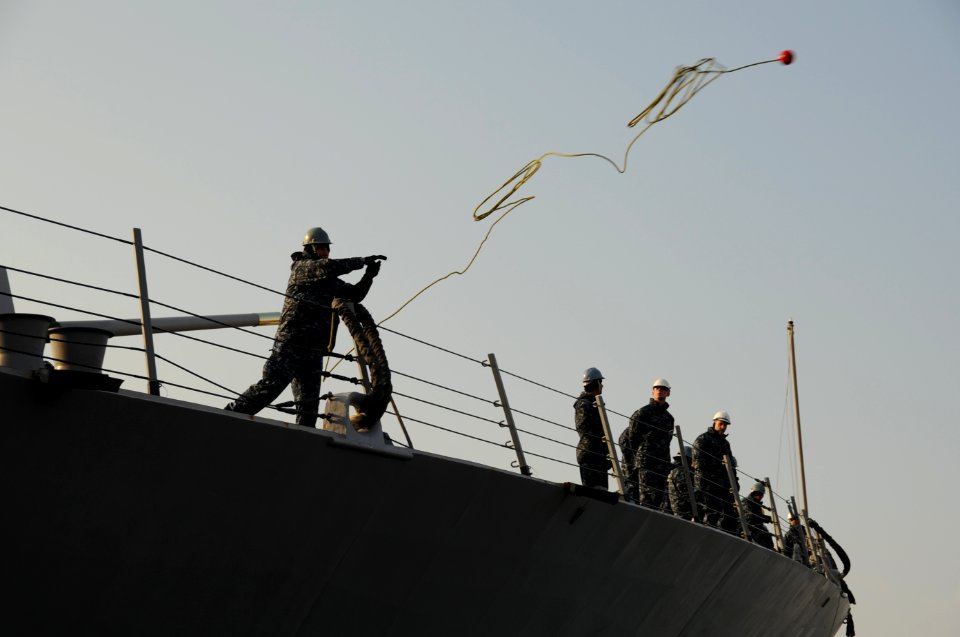 US Navy 110205-N-8623S-072 A Sailor aboard the guided-missile destroyer USS Gridley (DDG 101) tosses a mooring line across the bow as the ship arri