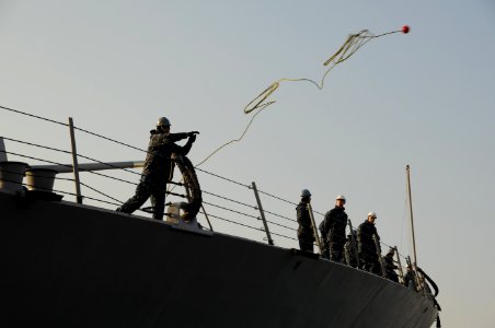 US Navy 110205-N-8623S-072 A Sailor aboard the guided-missile destroyer USS Gridley (DDG 101) tosses a mooring line across the bow as the ship arri