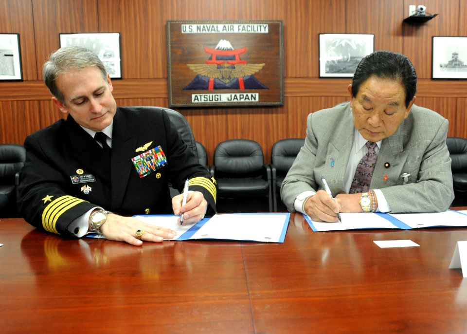 US Navy 110202-N-2858S-085 Capt. Eric Gardner signs a Memorandum of Agreement with Keishu Tanaka in the headquarters building at NAF Atsugi