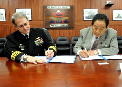 US Navy 110202-N-2858S-085 Capt. Eric Gardner signs a Memorandum of Agreement with Keishu Tanaka in the headquarters building at NAF Atsugi