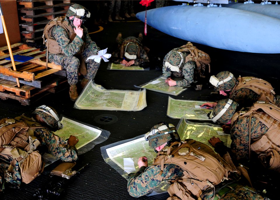 US Navy 110203-N-5538K-248 Marines assigned to the 31st Marine Expeditionary Unit practice land navigation techniques in the hangar bay of the forw