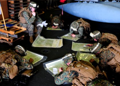 US Navy 110203-N-5538K-248 Marines assigned to the 31st Marine Expeditionary Unit practice land navigation techniques in the hangar bay of the forw