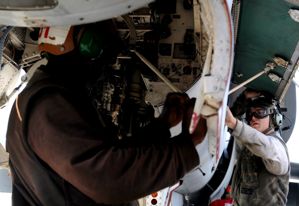 US Navy 110203-N-8040H-115 Aviation Machinist's Mate Airman Ablam Agoudavi and Aviation Electrician's Mate 3rd Class Jason Correll perform pre-flig