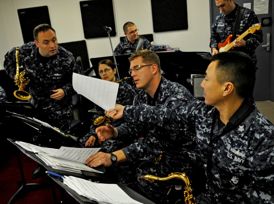US Navy 110203-N-8721D-027 Sailors assigned to the U.S. 7th Fleet Band, Far East Edition, go over music sheets as they prepares for practice at Fle