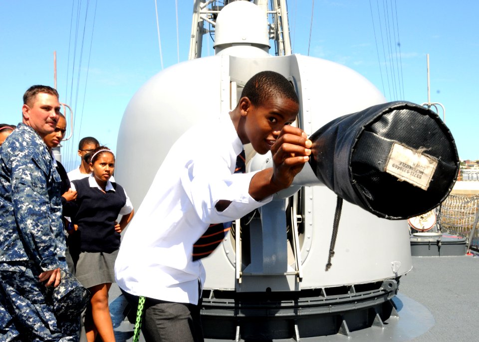 US Navy 110209-N-5085J-249 A student from the Cape Academy inspects the 76-mm cannon aboard USS Stephen W. Groves (FFG 29) during a tour of the shi