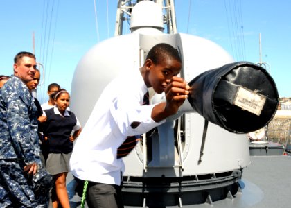 US Navy 110209-N-5085J-249 A student from the Cape Academy inspects the 76-mm cannon aboard USS Stephen W. Groves (FFG 29) during a tour of the shi