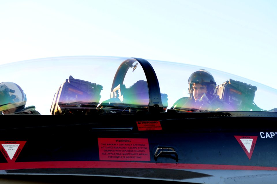 US Navy 110203-N-4590G-499 Texas Gov. Rick Perry looks from the cockpit of an F-A-18F Super Hornet assigned to the Black Knights of Strike Fighter