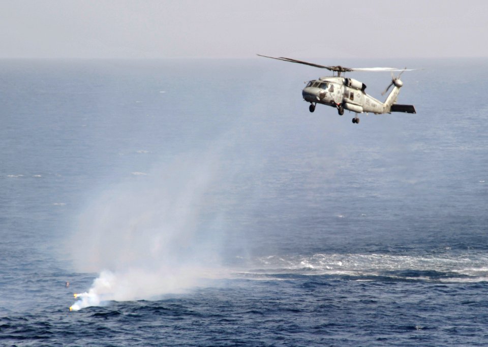 US Navy 110204-N-7981E-106 An HH-60H Sea Hawk helicopter arrives to deploy Rescue Swimmer Naval Aircrewman 3rd Class Toni Jester to recover a Sailo