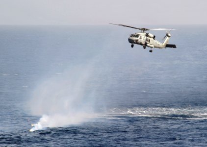 US Navy 110204-N-7981E-106 An HH-60H Sea Hawk helicopter arrives to deploy Rescue Swimmer Naval Aircrewman 3rd Class Toni Jester to recover a Sailo