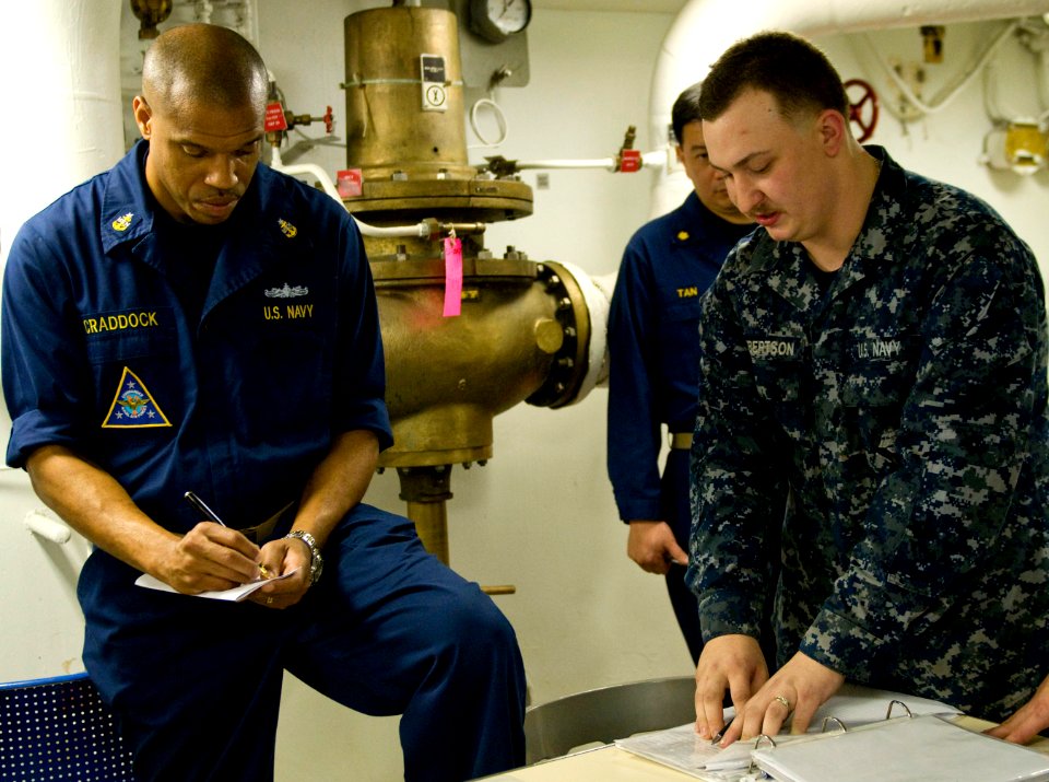 US Navy 110203-N-7488A-118 Senior Chief Electronics Technician Stephon Craddock conducts maintenance training with Logistics Specialist Seaman Ryan