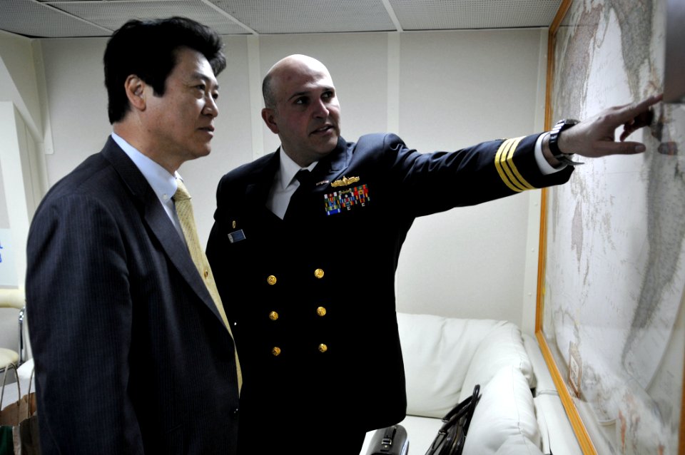 US Navy 110204-N-9818V-130 Cmdr. Dennis Velez, commanding officer of the guided-missile destroyer USS Fitzgerald (DDG 62), speaks with Fumiyuki Sai