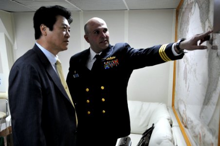 US Navy 110204-N-9818V-130 Cmdr. Dennis Velez, commanding officer of the guided-missile destroyer USS Fitzgerald (DDG 62), speaks with Fumiyuki Sai photo