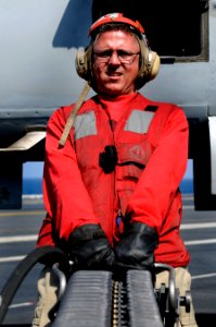 US Navy 110203-N-8040H-304 Chief Aviation Ordnanceman Jeffrey Campbell times a linkless ammunition loading system during an ordnance exercise aboar