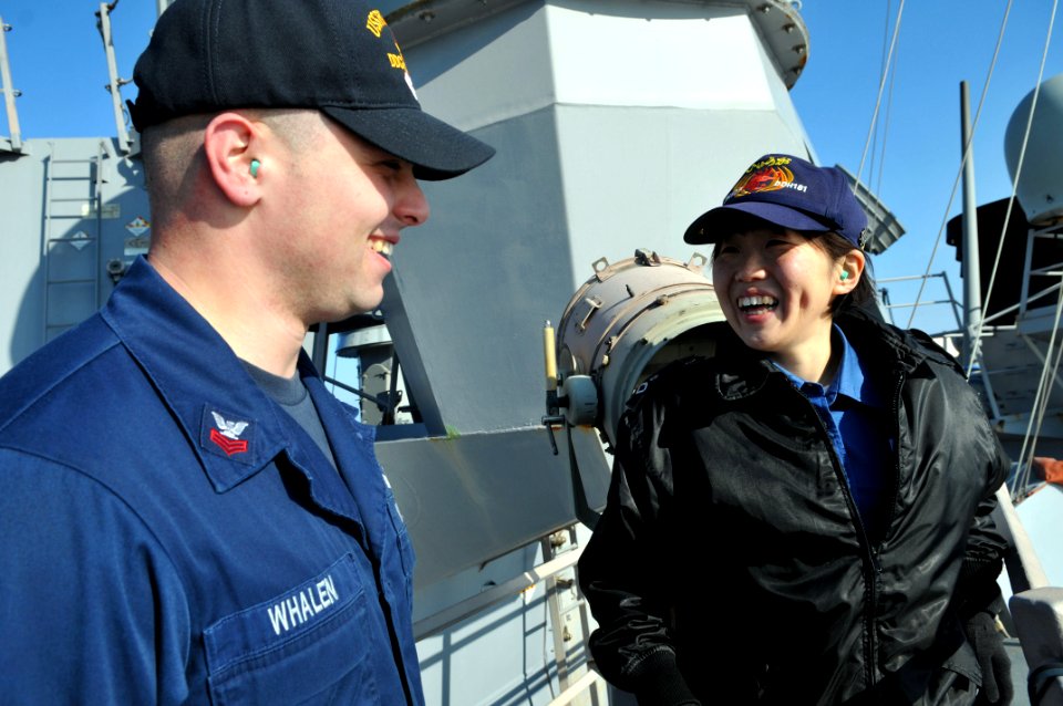 US Navy 110203-N-9818V-077 Sonar Technician (Surface) 1st Class Joseph Whalen speaks with Japan Maritime Self-Defense Force Signalman 3rd Class Rik