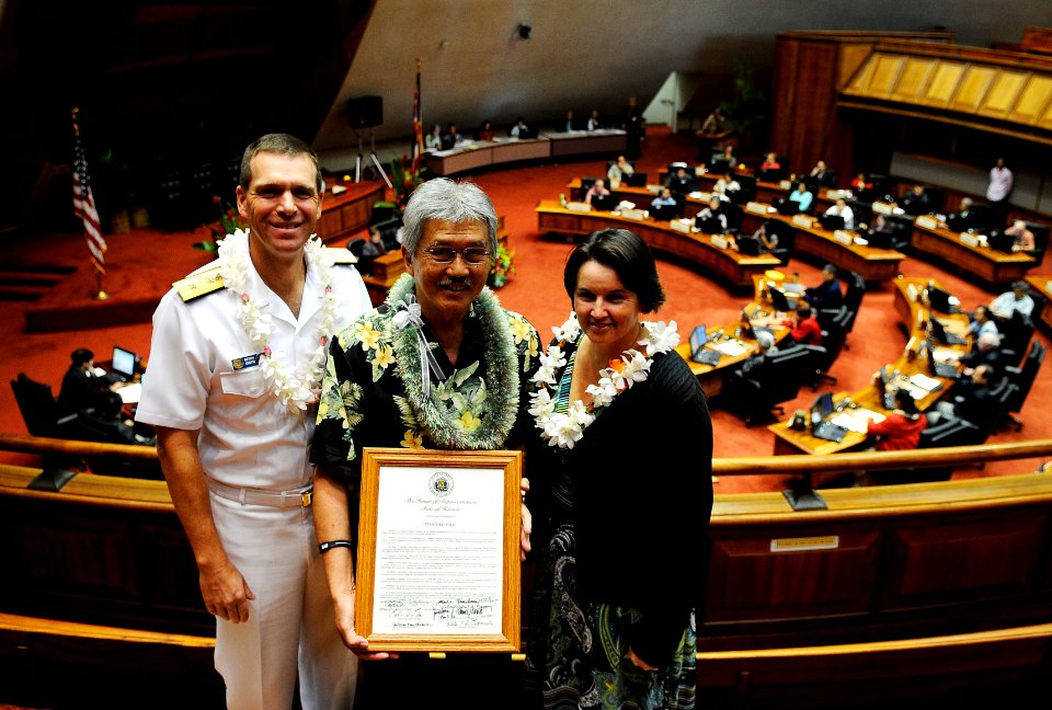 US Navy 110204-N-WP746-069 Stanford Yuen, center, the inter-governmental affairs executive assistant for Commander, Navy Region Hawaii, receives a