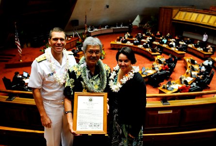 US Navy 110204-N-WP746-069 Stanford Yuen, center, the inter-governmental affairs executive assistant for Commander, Navy Region Hawaii, receives a