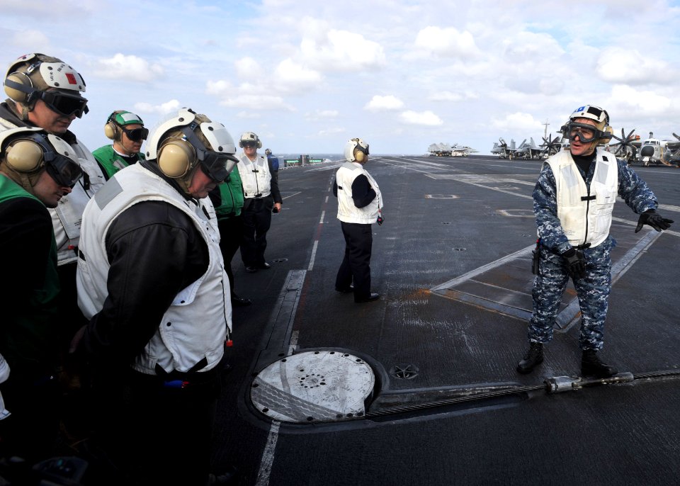 US Navy 110204-N-0569K-022 Capt. Ryan B. Scholl explains the operation of the arresting gear wire aboard USS Enterprise (CVN 65) to distinguished v