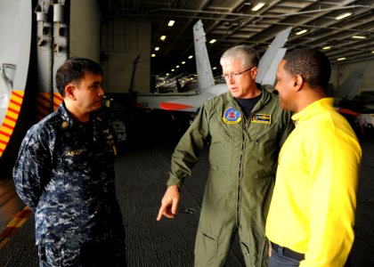 US Navy 110204-N-3374C-153 Vice Adm. Daniel P. Holloway, center, and Command Master Chief Glenn Mallo, left, talk to a Sailor from USS George H.W