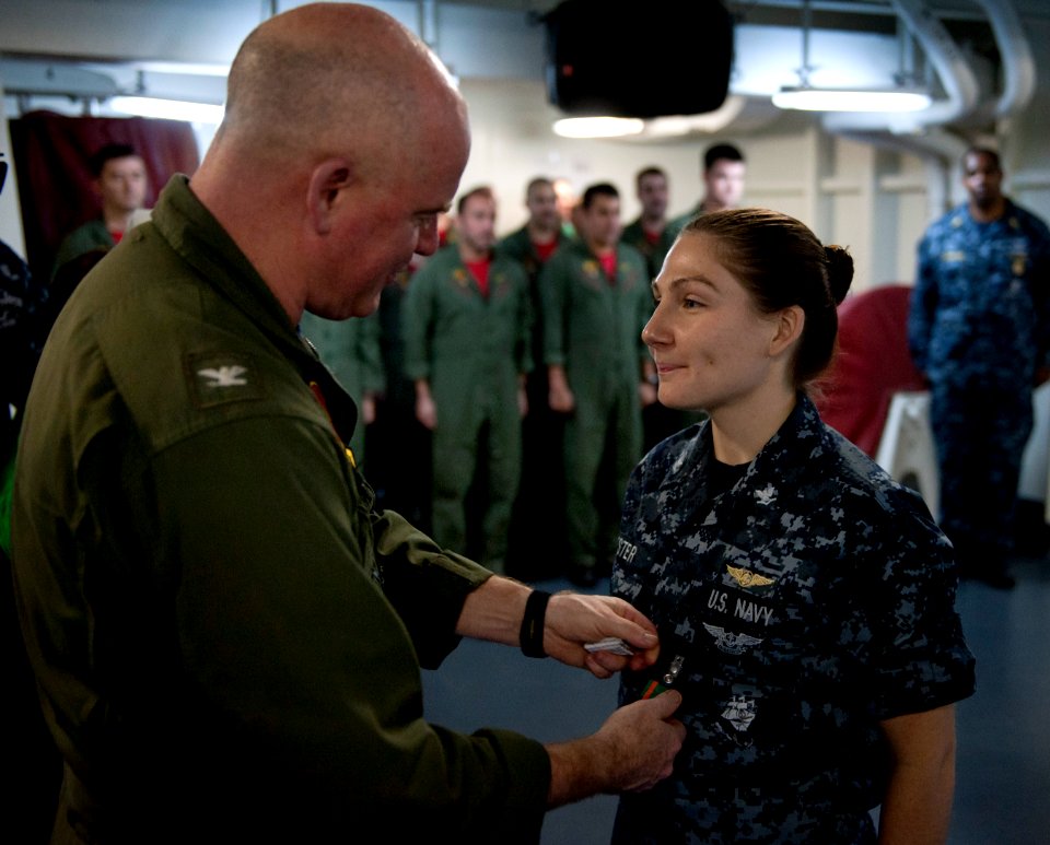 US Navy 110204-N-7981E-745 Capt. Stephen P. McInerney, commander of Carrier Air Wing (CVW) 17, awards the Navy and Marine Corps Achievement Medal t