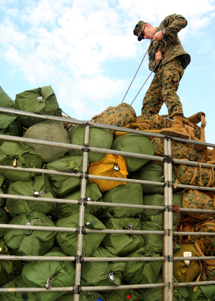 US Navy 110208-N-5538K-073 A Marine ties down sea bags during exercise Cobra Gold 2011