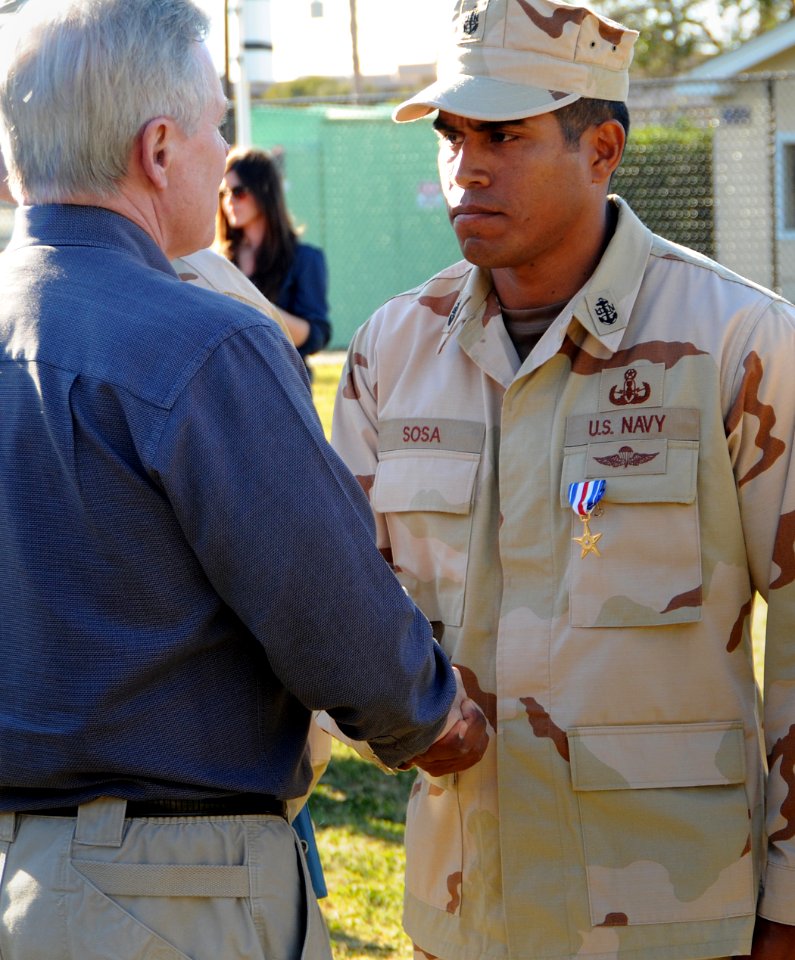 US Navy 110211-N-DO222-020 Secretary of the Navy (SECNAV) the Honorable Ray Mabus congratulates Chief Explosive Ordinance Disposal technician Gerar