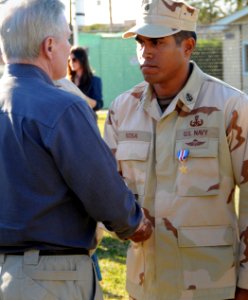US Navy 110211-N-DO222-020 Secretary of the Navy (SECNAV) the Honorable Ray Mabus congratulates Chief Explosive Ordinance Disposal technician Gerar