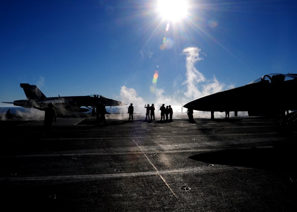 US Navy 110208-N-5503T-224 Sailors assigned to the air department of the aircraft carrier USS Ronald Reagan (CVN 76) position an F-A-18 Super Horne