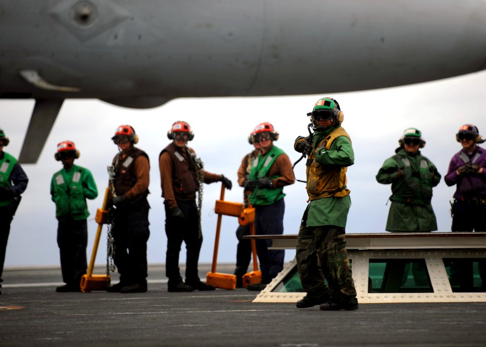 US Navy 110210-N-YZ751-334 A Sailor assigned to V-1 division of the air department of the aircraft carrier USS George H.W. Bush (CVN 77) signals to