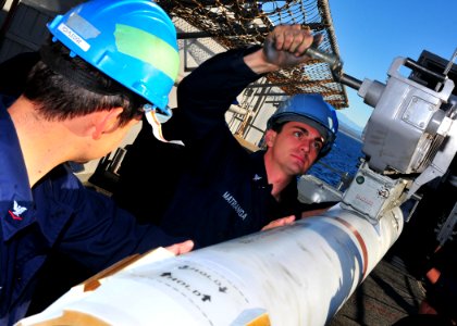 US Navy 110212-N-0841E-111 Fire Controlman 3rd Class Johnny Matranga loads a RIM-7P Sea Sparrow surface-to-air missile into a launcher aboard the a