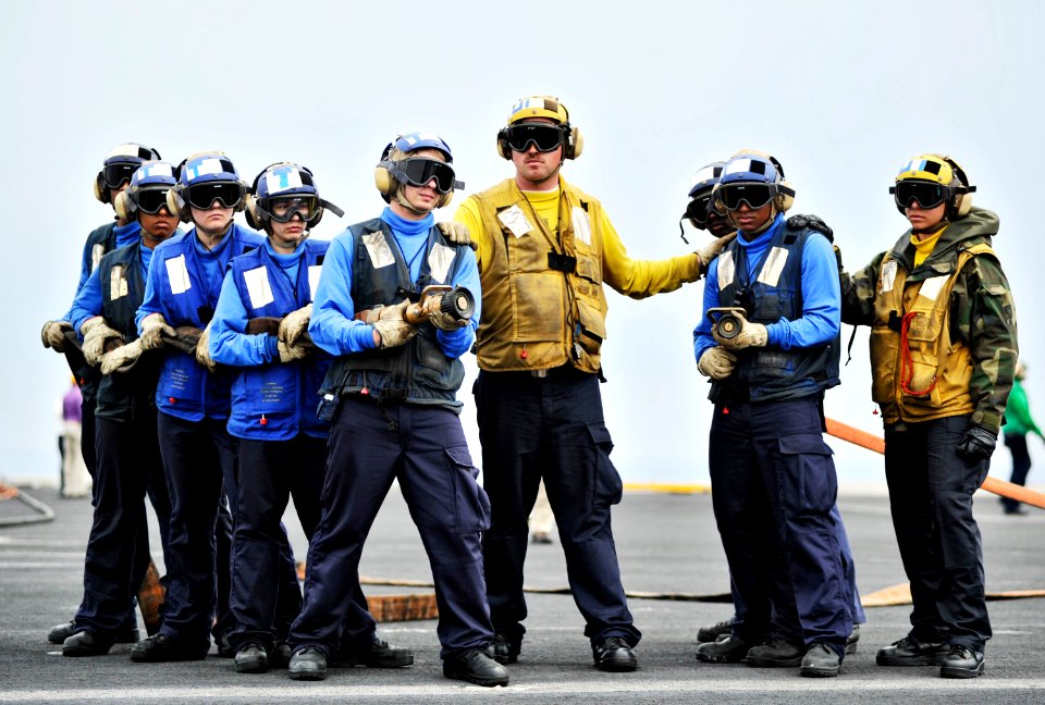US Navy 110211-N-6003P-057 Aviation Boatswain's Mate (Handling) 1st Class Christopher Connor, center, instructs Sailors in firefighting techniques