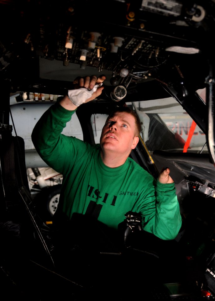 US Navy 110207-N-5646R-009 A Sailor performs preventative maintenance on a Sea Hawk helicopter aboard the aircraft carrier USS Enterprise (CVN 65)
