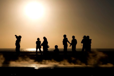 US Navy 110207-N-7488A-426 Sailors wait for aircraft to be directed onto a catapult during flight operations aboard the Nimitz-class aircraft carri