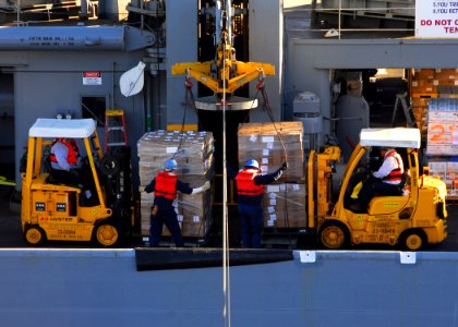 US Navy 110212-N-6908J-011 Civilian mariners aboard USNS Guadalupe (T-AO 200) stage several pallets of supplies to transfer to USS Ronald Reagan (C