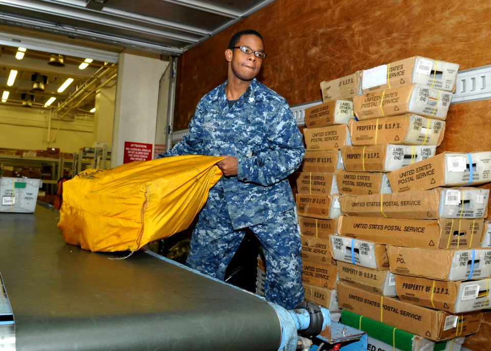 US Navy 110209-N-IO627-032 Logistics Specialist 3rd Class Jonathan Sanders loads mail into a truck at the Fleet and Industrial Supply Center (FISC)