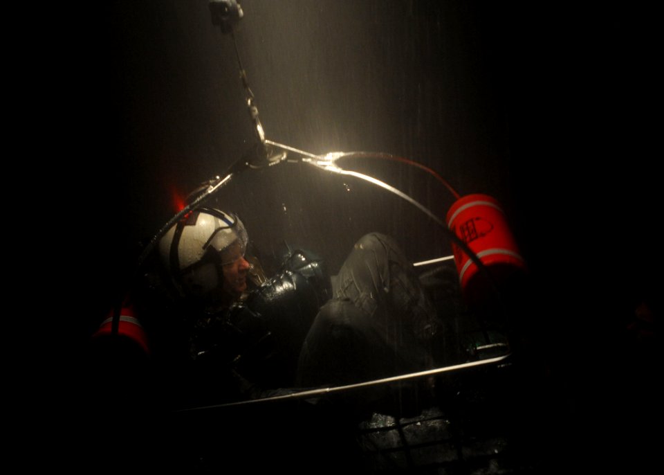 US Navy 110210-N-1810F-008 A student at the Aviation Survival Training Center ascends on a hoist during a simulated night exercise as part of an ai