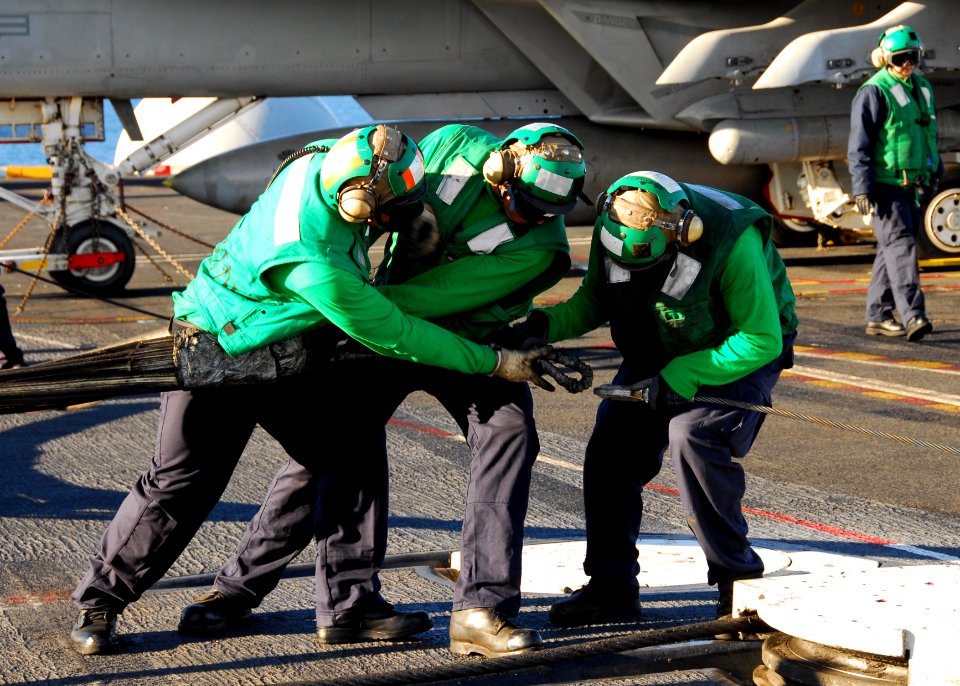 US Navy 110213-N-6908J-182 Sailors assigned to the air department set up the emergency barrier on the flight deck of the aircraft carrier USS Ronal