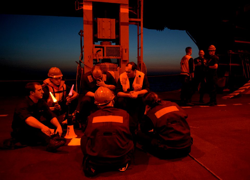 US Navy 110210-N-7981E-026 Sailors wait for a replenishment at sea to begin in the hangar bay of USS Carl Vinson (CVN 70)
