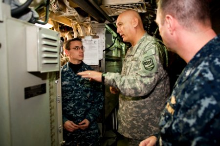 US Navy 110210-N-FG395-017 Army Gen. Raymond T. Odierno sks Missile Technician 1st Class Brandon Bates how he maintains the missiles aboard USS Rho