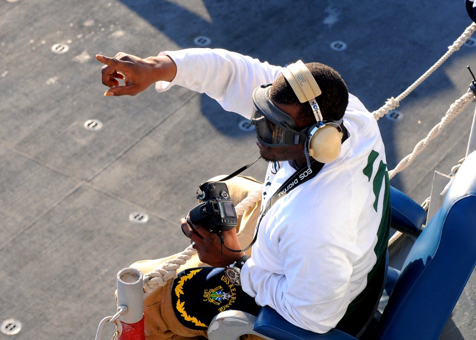 US Navy 110214-N-2908M-170 Derrick Martin from the Super Bowl XLV champion Green Bay Packers, watches flight operations aboard the amphibious assau