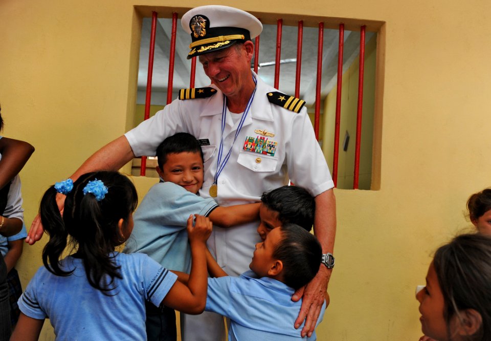 US Navy 110209-N-7589W-152 Cmdr. Mark Becker, mission commander of Southern Partnership Station 2011, hugs students at Colegio Liceo Alpha y Omega