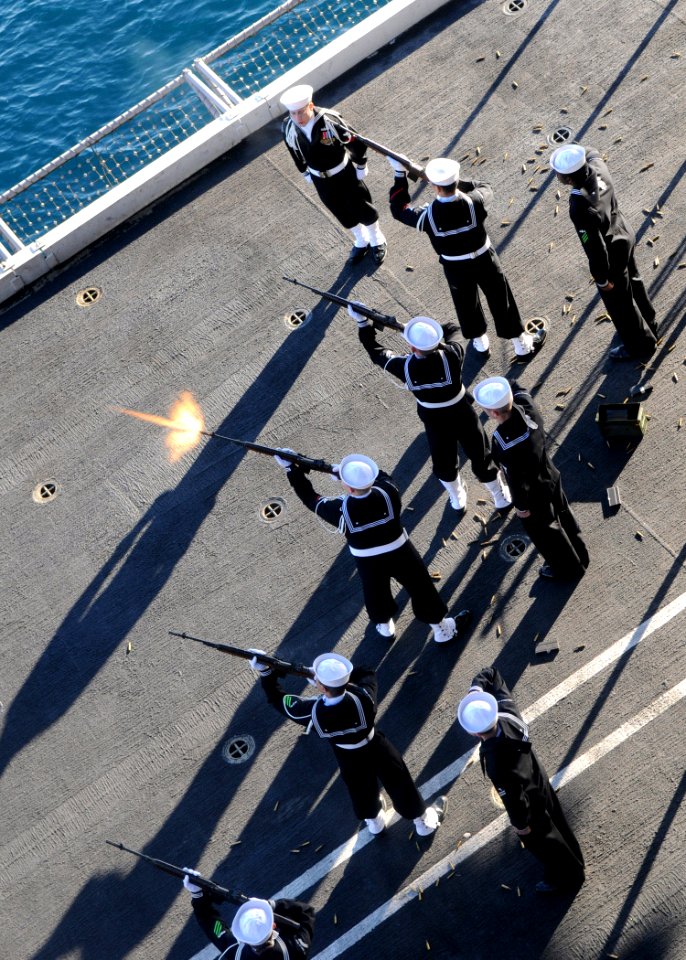 US Navy 110214-N-4590G-387 Members of the honor guard aboard the aircraft carrier USS Ronald Reagan (CVN 76) fire a rifle volley during a burial at photo
