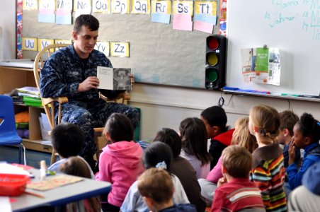 US Navy 110210-N-SF508-068 Aviation Ordnanceman Airman Bradley Spencer, from Scottsburg, Ind., reads about Dr. Martin Luther King Jr. to first grad