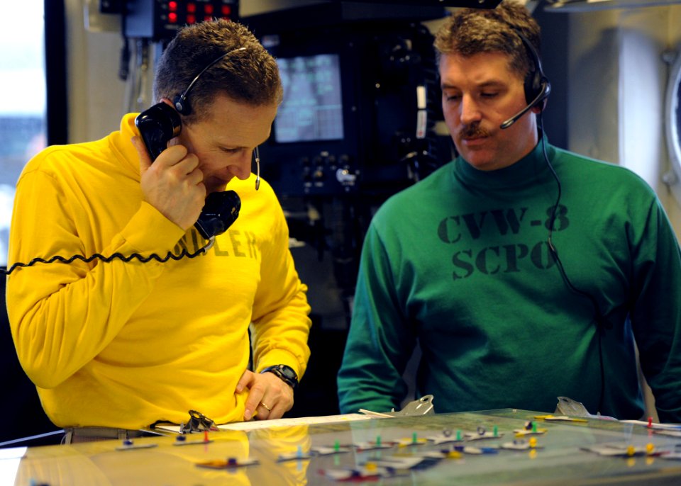 US Navy 110210-N-YZ751-879 Lt. Cmdr. Ronald G. Rancourt, left, aircraft handling officer aboard the aircraft carrier USS George H.W. Bush (CVN 77)