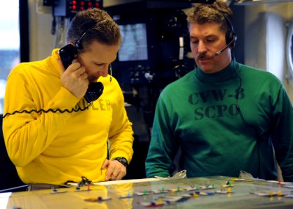 US Navy 110210-N-YZ751-879 Lt. Cmdr. Ronald G. Rancourt, left, aircraft handling officer aboard the aircraft carrier USS George H.W. Bush (CVN 77)